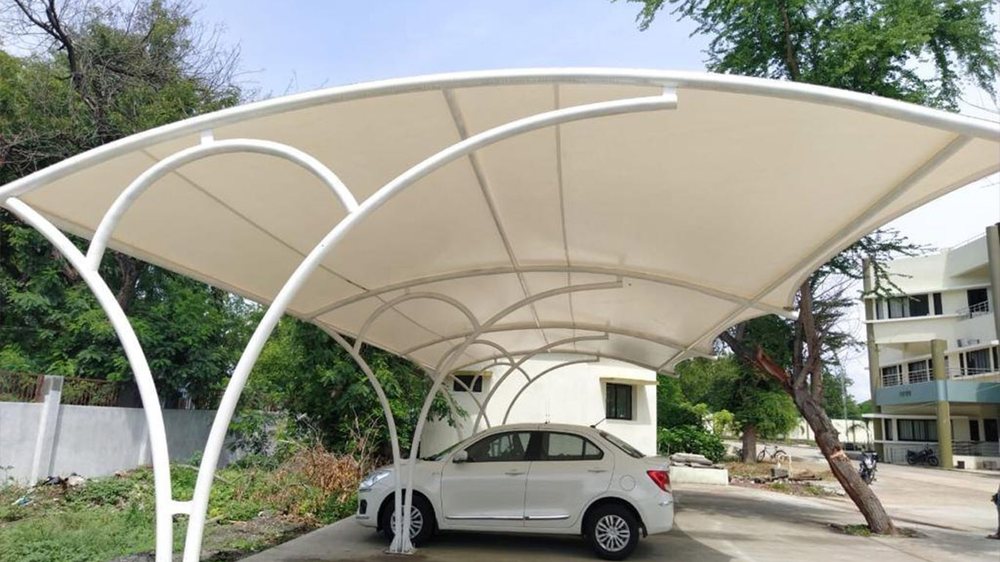 Curved tensile car parking shade structure covering a vehicle